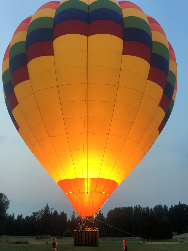 sunset hot air balloon landing at dusk