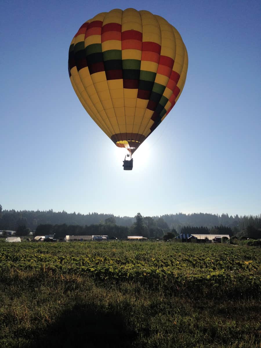 Sunrise hot air balloon flight over a field near Seattle